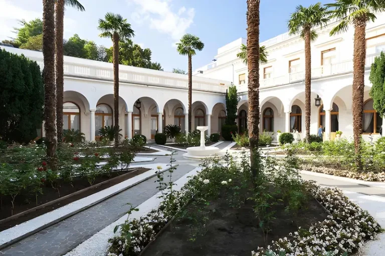 A serene view of a lush Marrakech garden featuring vibrant greenery and blooming flowers in