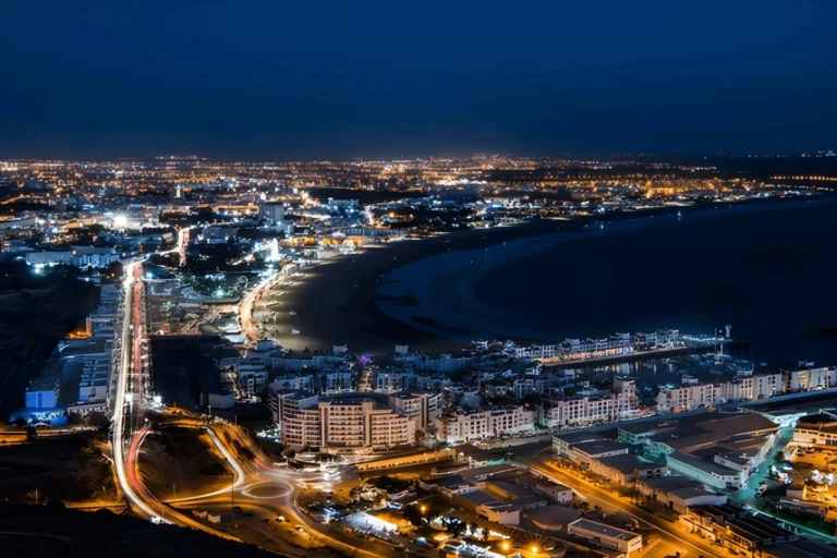 scene of agadir at night featuring a lively outdoor cafe filled with people enjoying